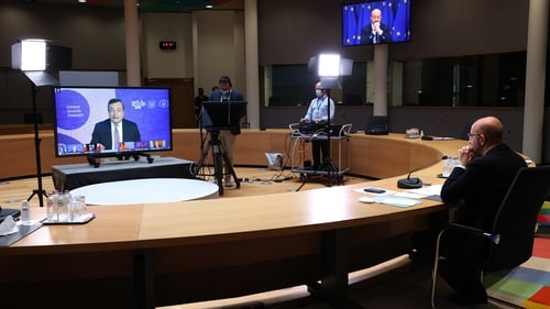 Charles Michel, president of the European Council, right, holds a virtual live stream video meeting with Mario Draghi during the G20 Global Health summit