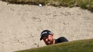 Lowry plays a shot from the sand on the 17th hole