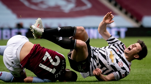 Harry Maguire (R) injured his ankle after Aston Villa's Anwar El Ghazi awkwardly landed on him.