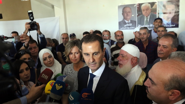 President Assad talks to the media after he and his wife Asma cast their votes in Douma
