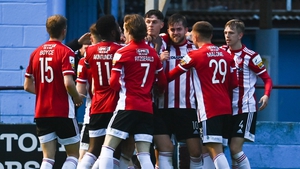 Will Patching is mobbed by his team-mates after scoring his and Derry's second goal of the night