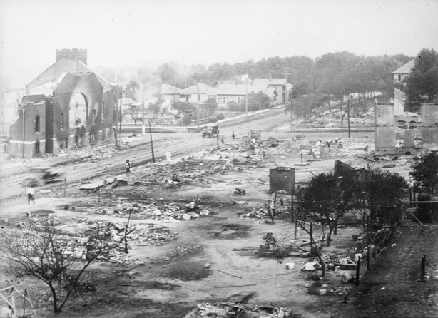 Photograph shows ruins of buildings, including a church, destroyed during the Tulsa Race Massacre. Photo: Library of Congress