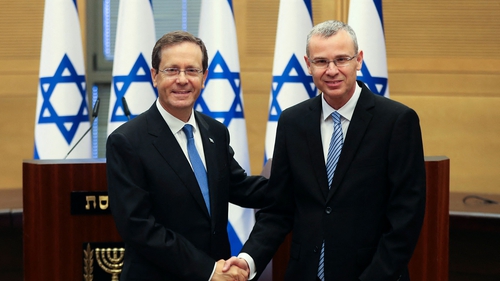 Isaac Herzog (L) shakes hands with Speaker of the Knesset Yariv Levin, after he was elected president