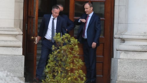Edwin Poots elbow bumping Micheál Martin after the talks, pictured with DUP MLA Paul Givan (L)