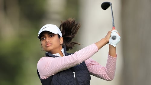 Megha Ganne plays her tee shot on 18