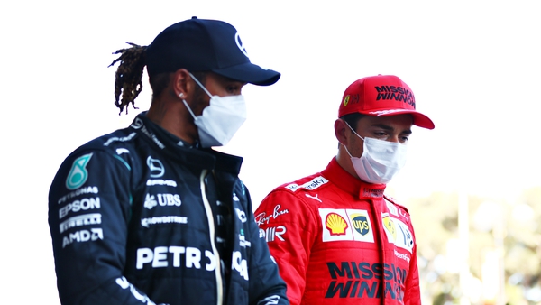 Lewis Hamilton (L) talks with Charles Leclerc after qualifying