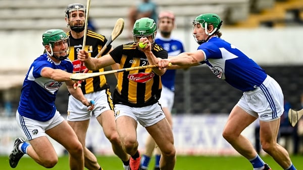 Kilkenny's Tommy Walsh is tackled by Eoin Gaughan, left, and Ross King of Laois