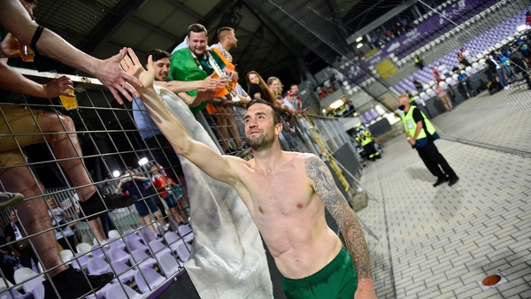 Shane Duffy greets some of the Ireland supporters inside Szusza Ferenc Stadion