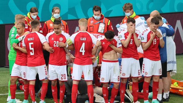 Danish players shield Eriksen as he receives treatment