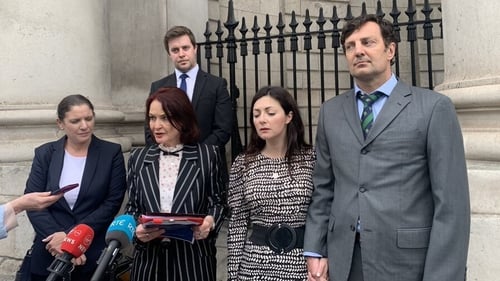 Rebecca Price (2R) and Patrick Kiely (R) outside the High Court