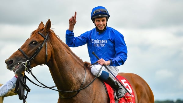 William Buick celebrates as he passes the post after riding Hurricane Lane to victory in the Dubai Duty Free Irish Derby