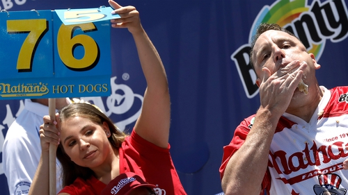 Joey Chestnut beat his own world record by downing 76 hot dogs and buns in 10 minutes