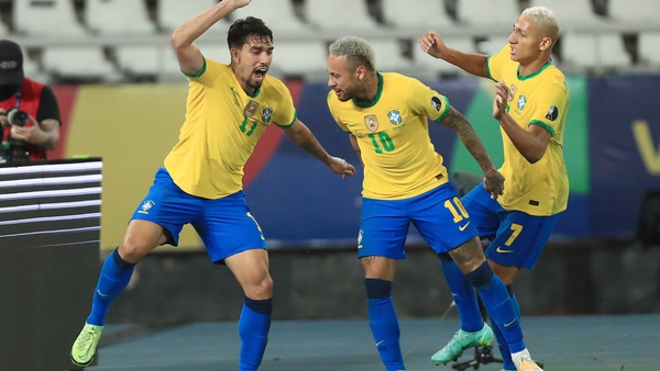 Lucas Paqueta (L) celebrates with team-mates Neymar Jr (C) and Richarlison after scoring for Brazil against Peru