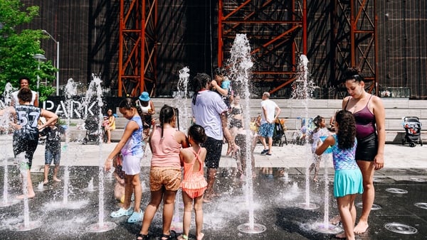 Children cool off in a park in Brooklyn, New York