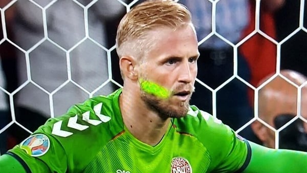 Kasper Schmeichel is targeted by a laser as he prepares to face Harry Kane's penalty