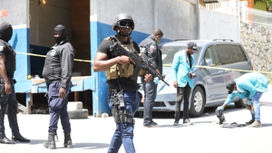 Haitian police patrol the area outside of the presidential residence