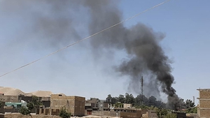 Smoke rises from houses amid ongoing fighting between Afghan security forces and Taliban fighters in Qala-i-Naw