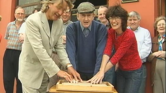 John B Keane casts his hands in clay to be transformed to bronze and placed outside the Gaiety Theatre, Dublin (2001)