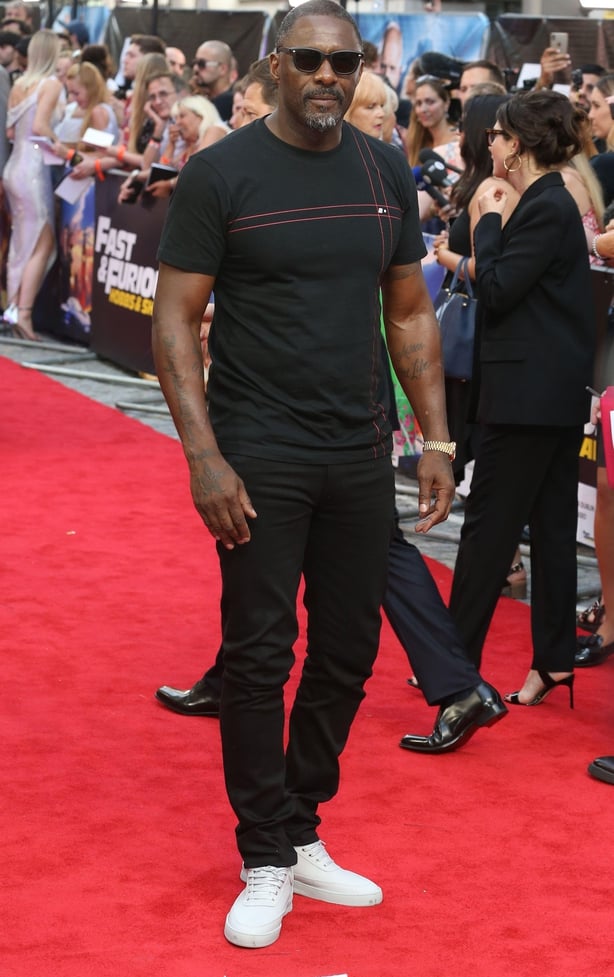 Idris Elba wearing trainers on the red carpet (Alamy/PA)