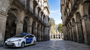 A Barcelona police patrol car is seen guarding the entrance to the Plaza Real due to the spread of the coronavirus