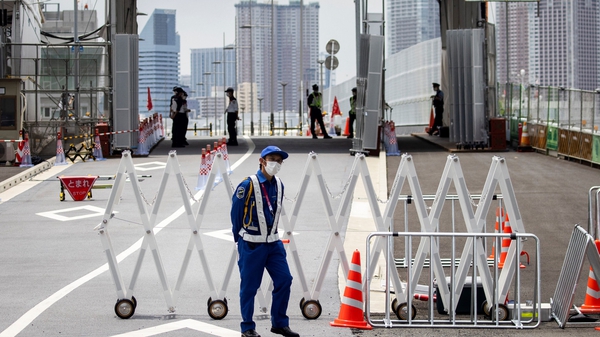 A security guard at the entrance to the Olympic Village in Tokyo