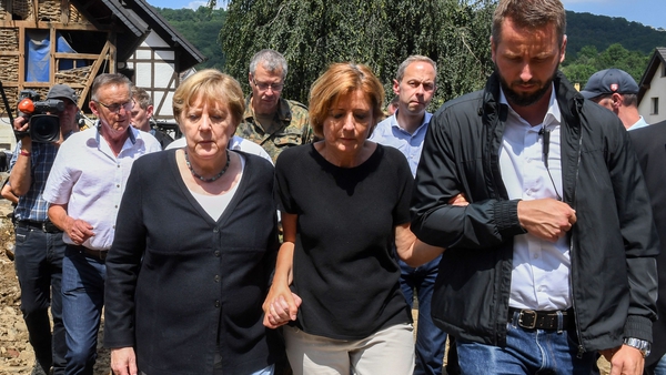 German Chancellor Angela Merkel and Rhineland-Palatinate State Premier Malu Dreyer talk as they visit the flood-ravaged village of Schuld, Germany