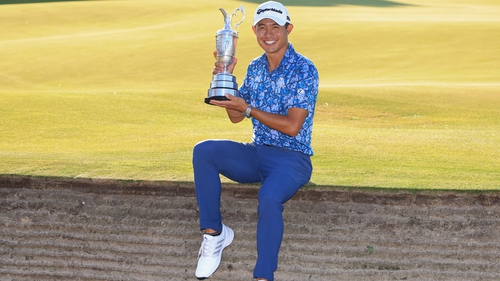 Collin Morikawa poses with the Claret Jug by the 18th green at Royal St George's