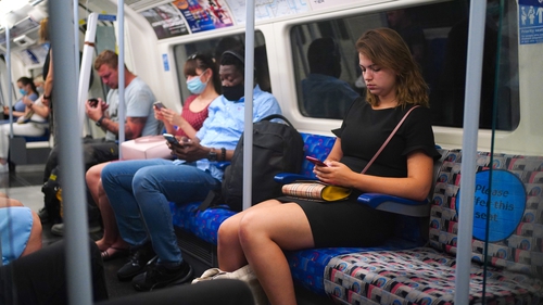 Commuters, some not wearing face masks, on the tube in London this morning