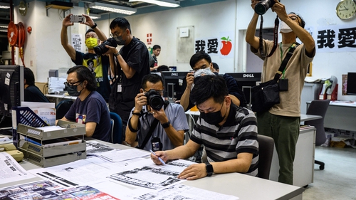 Lam Man-chung photographed in June proof reading the final edition of the Apple Daily