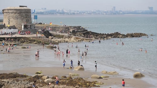 People enjoy the weather on Seapoint Beach in Dublin