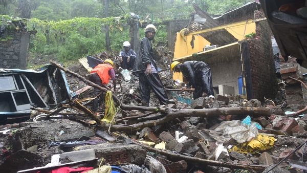 Workers clear debris after a landslide, at New Bharat Nagar in Mumbai earlier this week