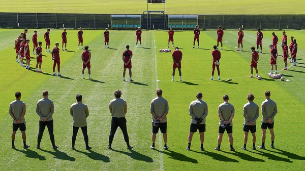 The Liverpool squad observes a 97-second silence for Andrew Devine