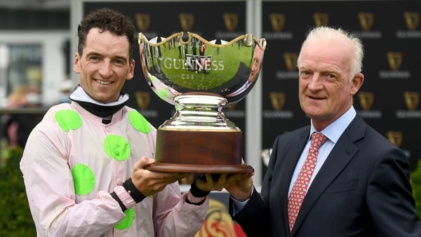 Jockey Patrick Mullins celebrates with his father and trainer Willie Mullins