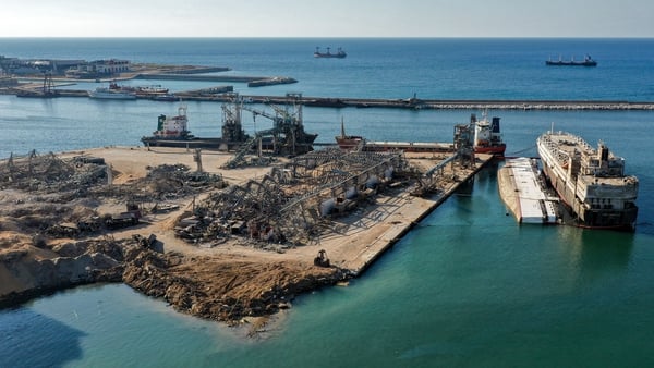 An aerial view of the flattened warehouse at the port of Beirut next to the crater left by the explosion last year