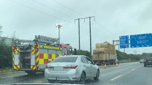 A number of bales are understood to have fallen from the lorry, causing traffic congestion
