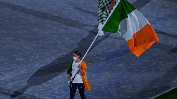 Natalya Coyle carries the Irish flag at the closing ceremony