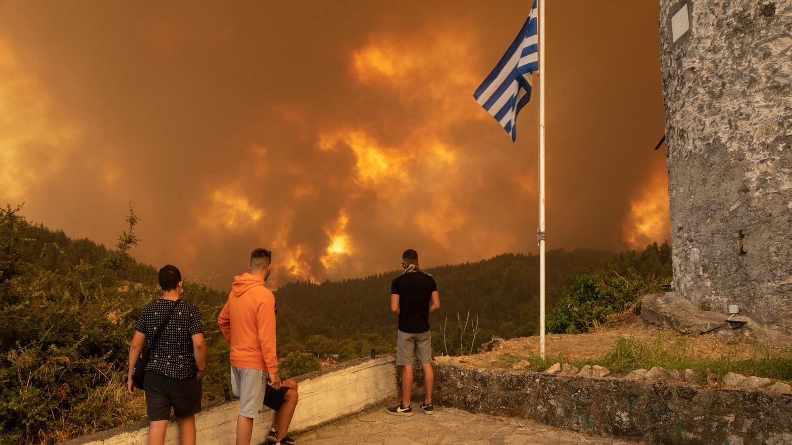 Hundreds flee as fires rip through Greek island