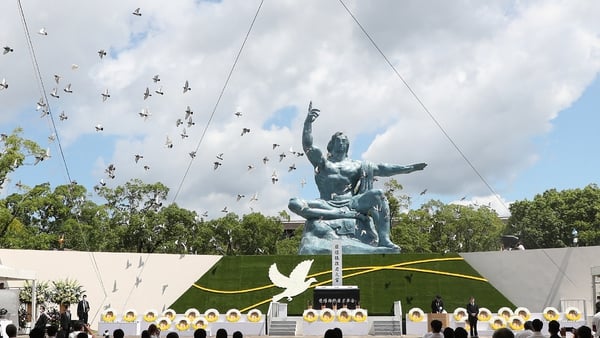 Doves fly during a memorial service for atomic bombing victims at the Nagasaki Peace Park