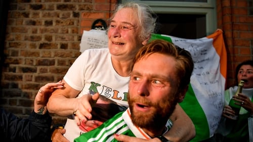 Kellie Harrington's mother Yvonne and older brother Christopher celebrate outside the family home on Portland Row