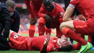 Andy Robertson receives treatment after sustaining an ankle injury against Athletic Bilbao