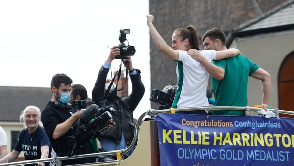 Kellie Harrington and Emmet Brennan wave from the open-top bus as Kellie's mother Yvonne (far left) looks on (Pic: Rolling News)