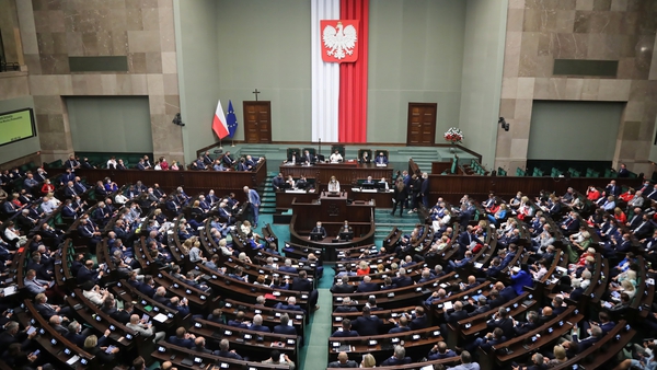 Polish MPs attend a parliamentary debate on the new media law