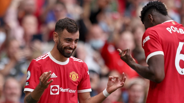 Bruno Fernandes celebrates scoring his hat-trick goal with Paul Pogba