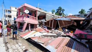 The work of recovering what materials can begins after a 7.2-magnitude earthquake struck Haiti