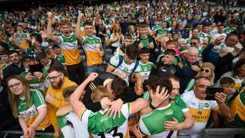 Offaly players celebrate with supporters after the final whistle
