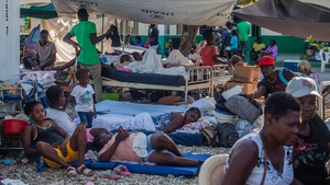 Haitians rest outdoors after a 7.2-magnitude earthquake on 15 August, 2021 in Les Cayes, Haiti