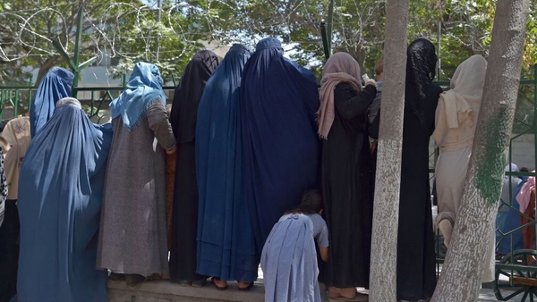 Internally displaced Afghan women, who fled from the northern province due to battles between Taliban and Afghan security forces, gather to receive free food being distributed in Kabul last week