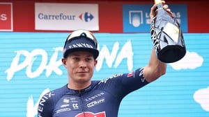 Jasper Philipsen celebrates on the podium after winning the fifth stage
