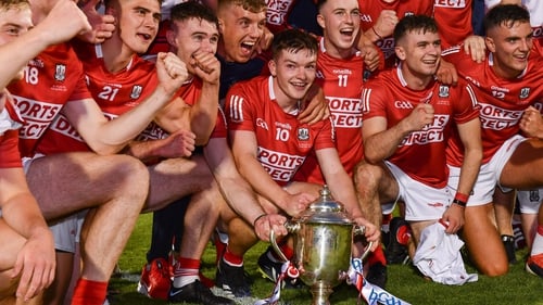Cork players celebrate with the trophy