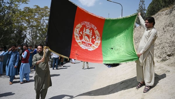Afghans celebrate the 102th Independence Day of Afghanistan with the national flag in Kabul